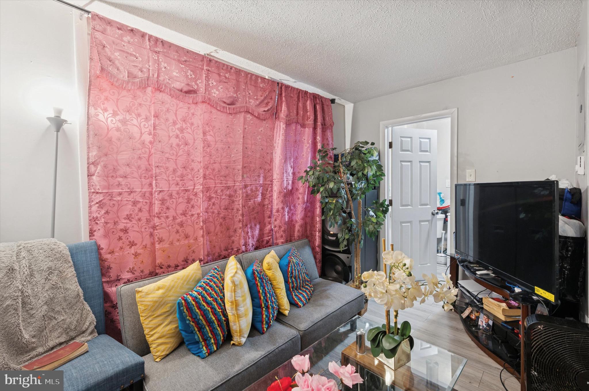 425 Main Street Darby, PA 19023 - Photo 8 of 18 a living room with furniture and a flat screen tv