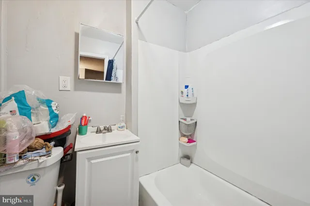a bathroom with a sink vanity mirror and toilet