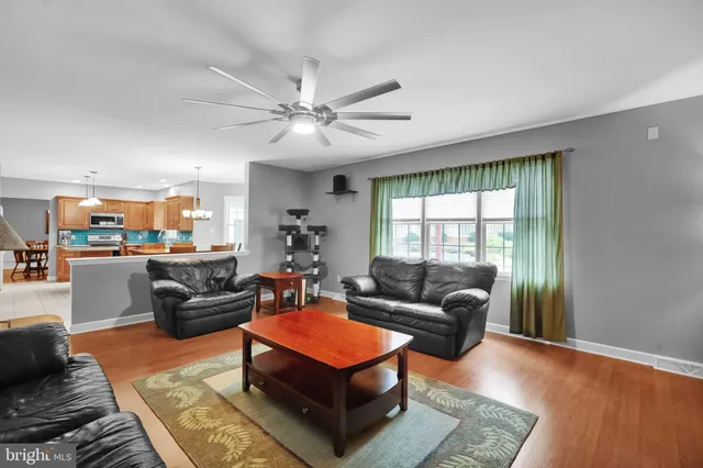 a kitchen with granite countertop a stove a sink and a refrigerator