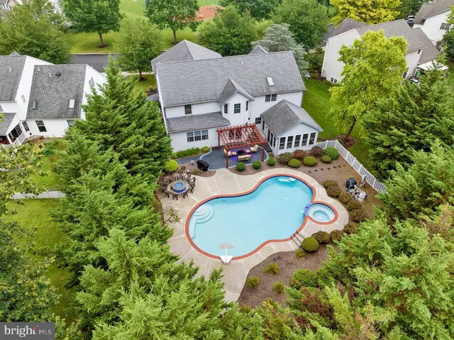 a view of a house with a swimming pool and sitting area