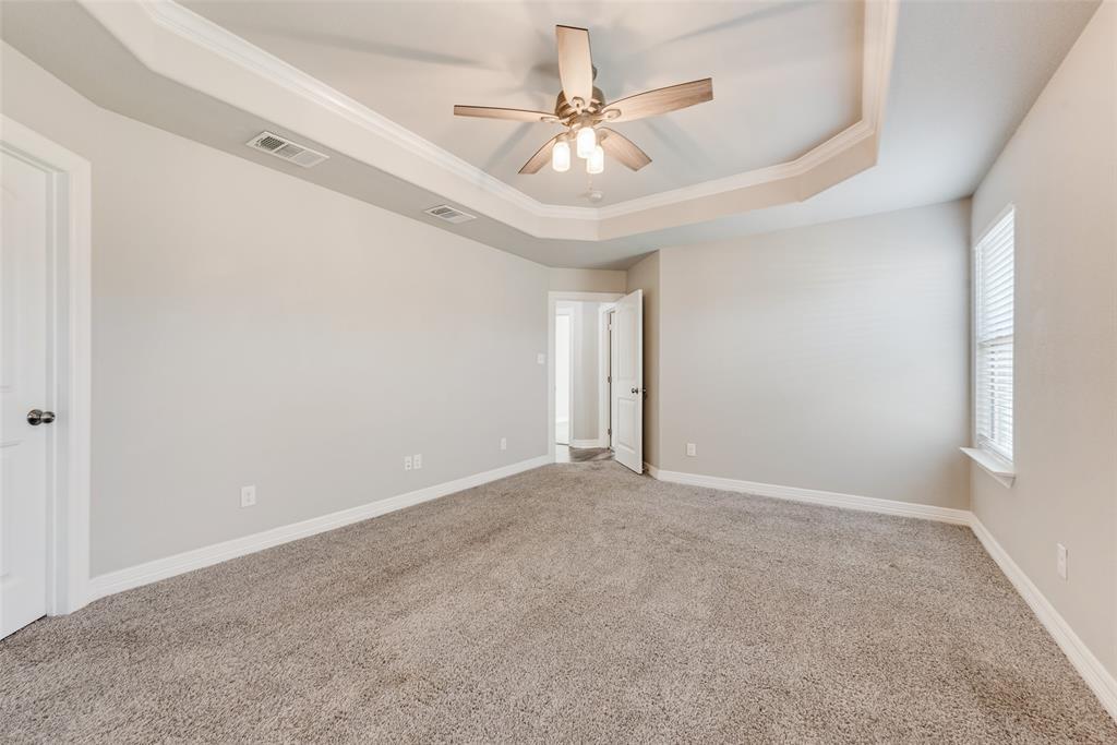 625 Copenhavr Street Pilot Point, TX 76258 - Photo 13 of 20 Unfurnished room featuring a tray ceiling, carpet floors, a ceiling fan, and crown molding