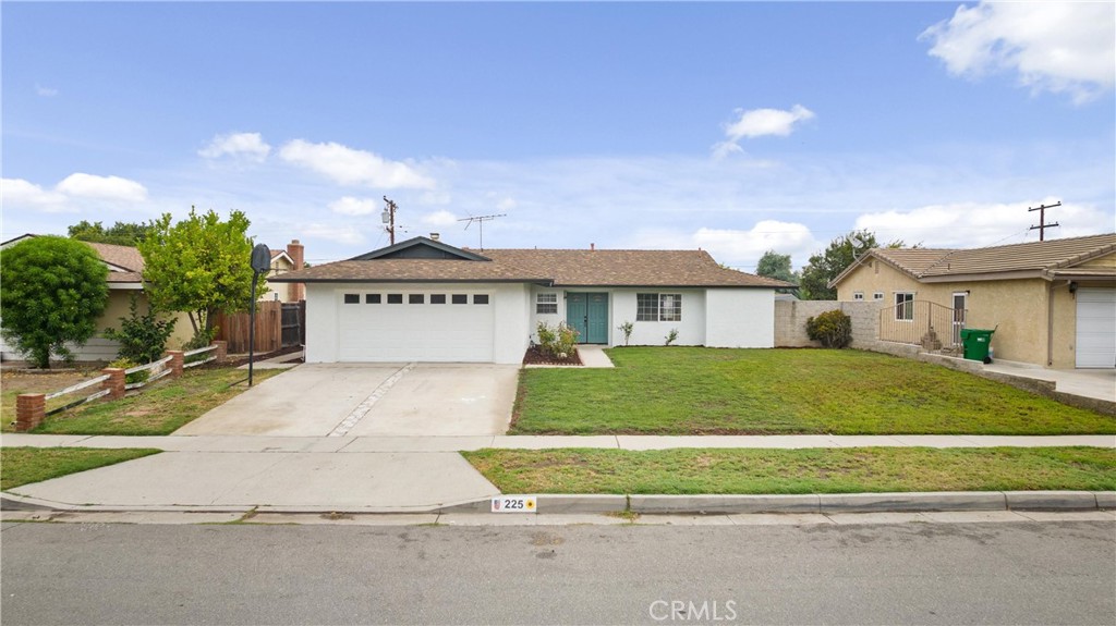 a front view of a house with a garden and garage
