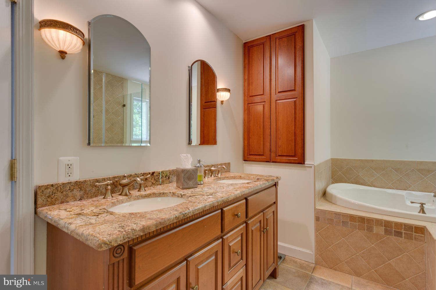 1524 Laurel Hill Road Vienna, VA 22182 - Photo 13 of 29 a bathroom with a granite countertop sink and a mirror