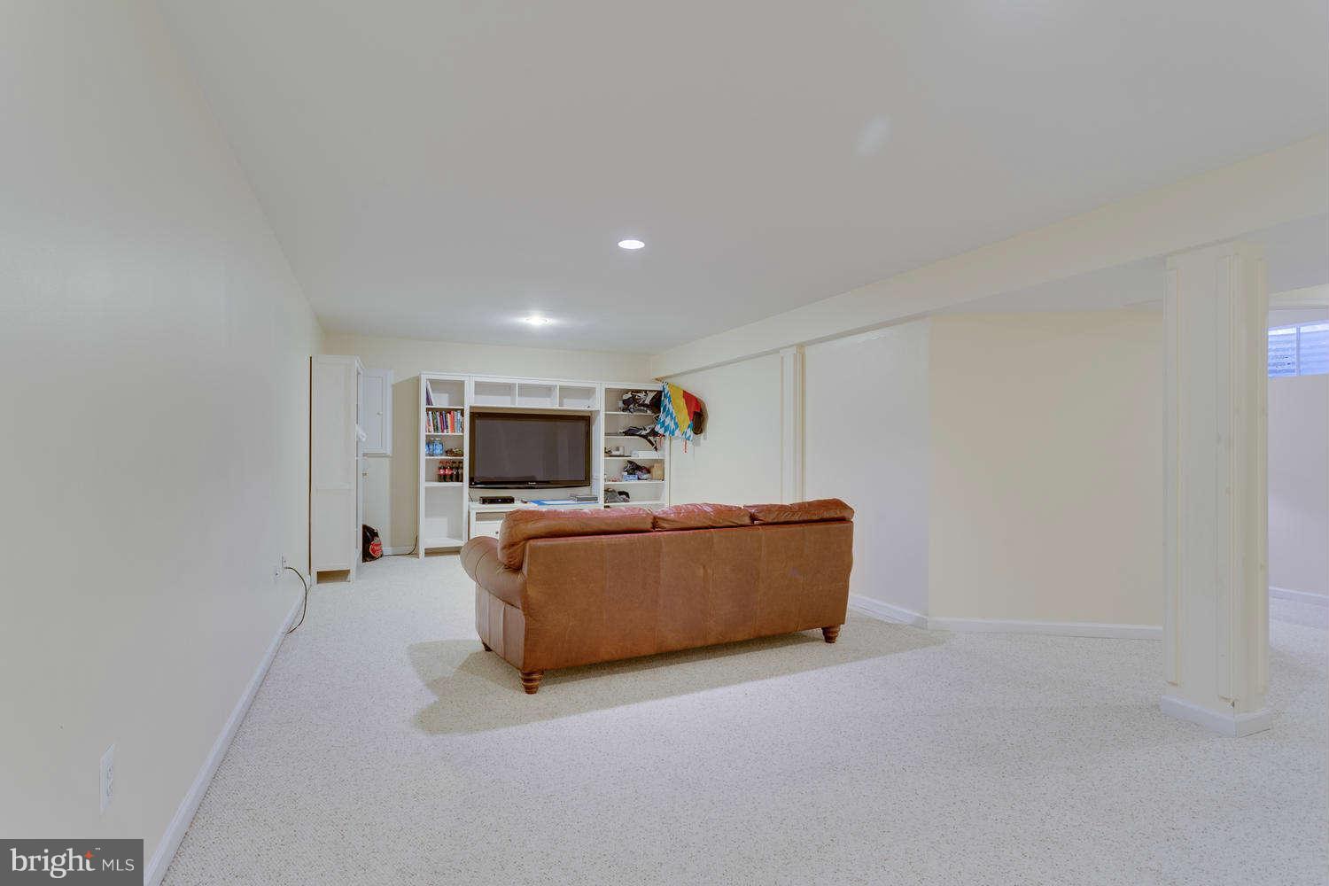 1524 Laurel Hill Road Vienna, VA 22182 - Photo 21 of 29 a living room with furniture and a flat screen tv