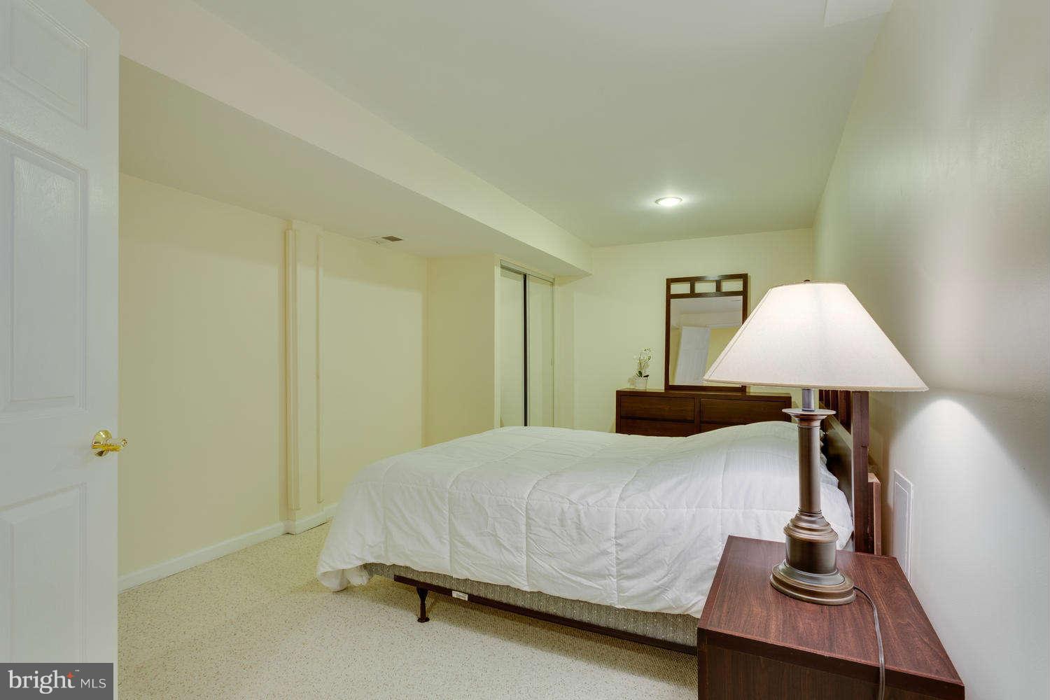 1524 Laurel Hill Road Vienna, VA 22182 - Photo 24 of 29 a bedroom with a bed and lamp