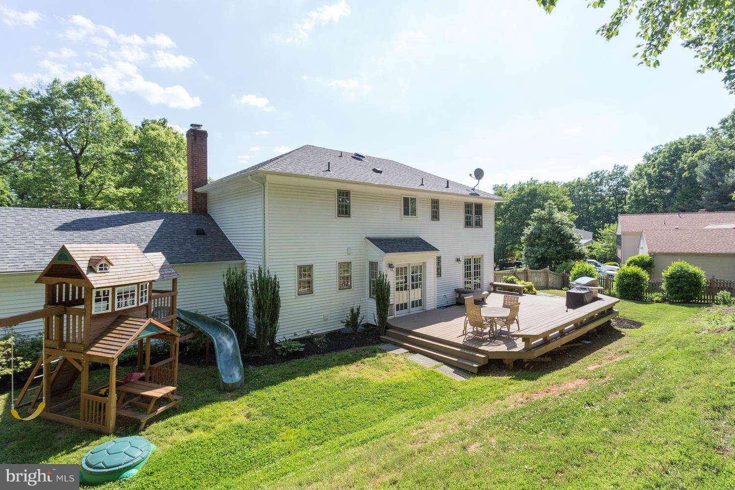 1524 Laurel Hill Road Vienna, VA 22182 - Photo 25 of 29 a view of a patio with table and chairs potted plants and a palm tree