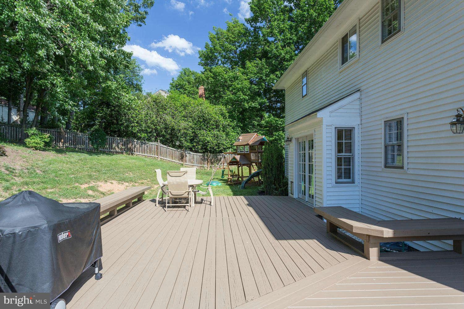 1524 Laurel Hill Road Vienna, VA 22182 - Photo 28 of 29 a view of a patio with table and chairs with wooden floor and fence