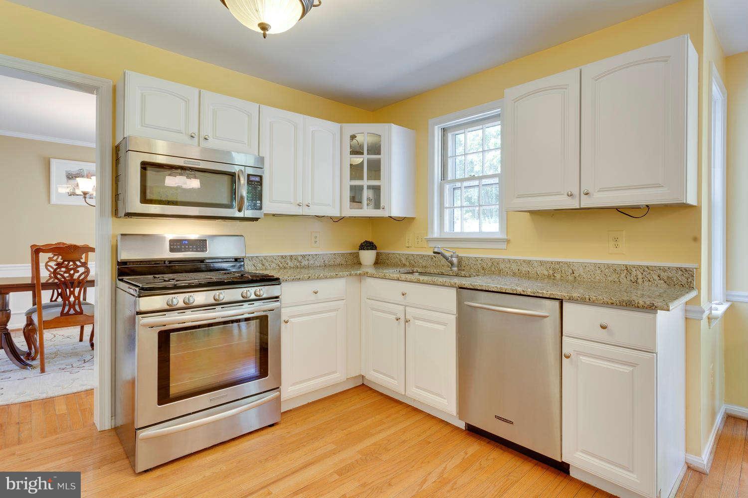 1524 Laurel Hill Road Vienna, VA 22182 - Photo 4 of 29 a kitchen with stainless steel appliances granite countertop a stove a sink and a microwave