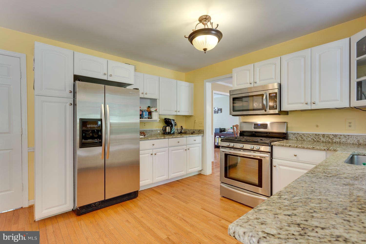 1524 Laurel Hill Road Vienna, VA 22182 - Photo 5 of 29 a kitchen with granite countertop a refrigerator stove top oven and sink