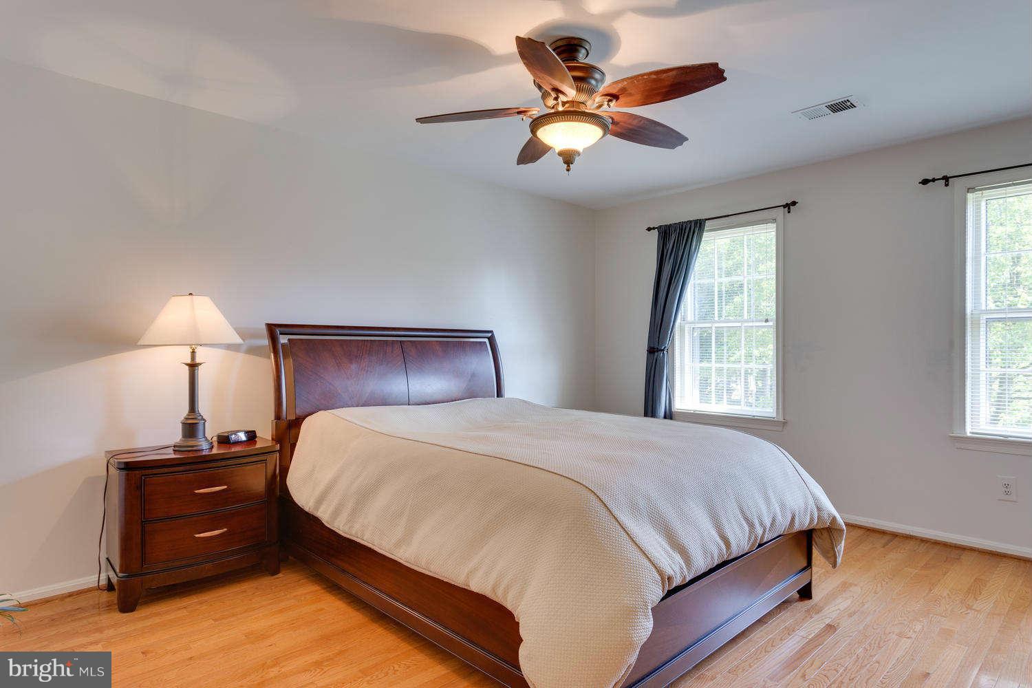 1524 Laurel Hill Road Vienna, VA 22182 - Photo 10 of 29 a bedroom with a bed and a chandelier