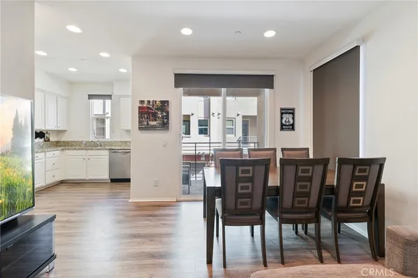 a kitchen with granite countertop white cabinets stainless steel appliances a sink and a window