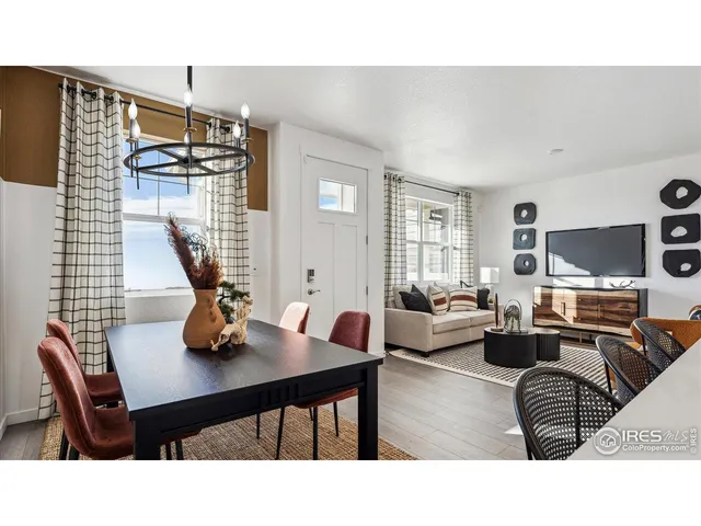 a living room with furniture a dining table and chairs
