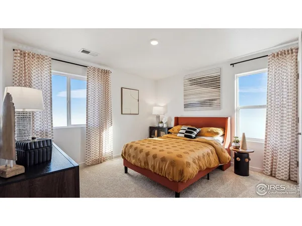 a living room with a bed furniture and a window