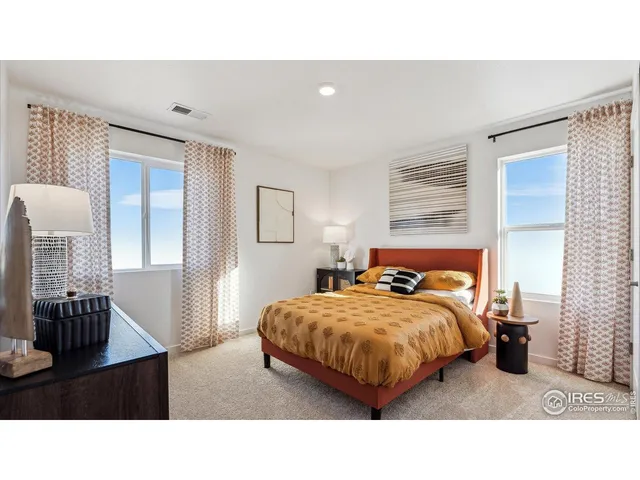 a living room with a bed furniture and a window