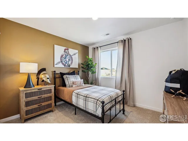 a living room with bed and a window