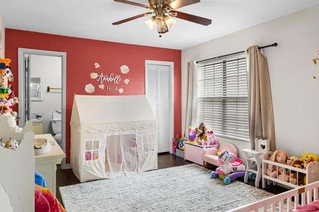a bedroom with furniture and a window