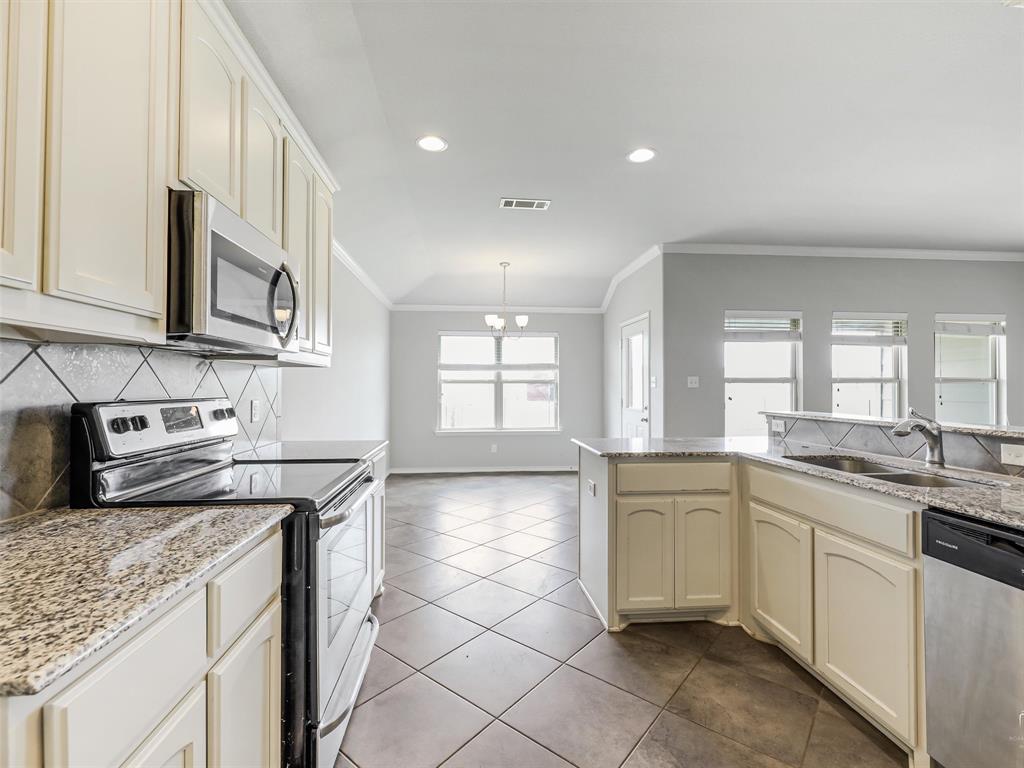 132 County Road 4213 Decatur, TX 76234 - Photo 9 of 27 a kitchen with stainless steel appliances granite countertop a sink stove and cabinets