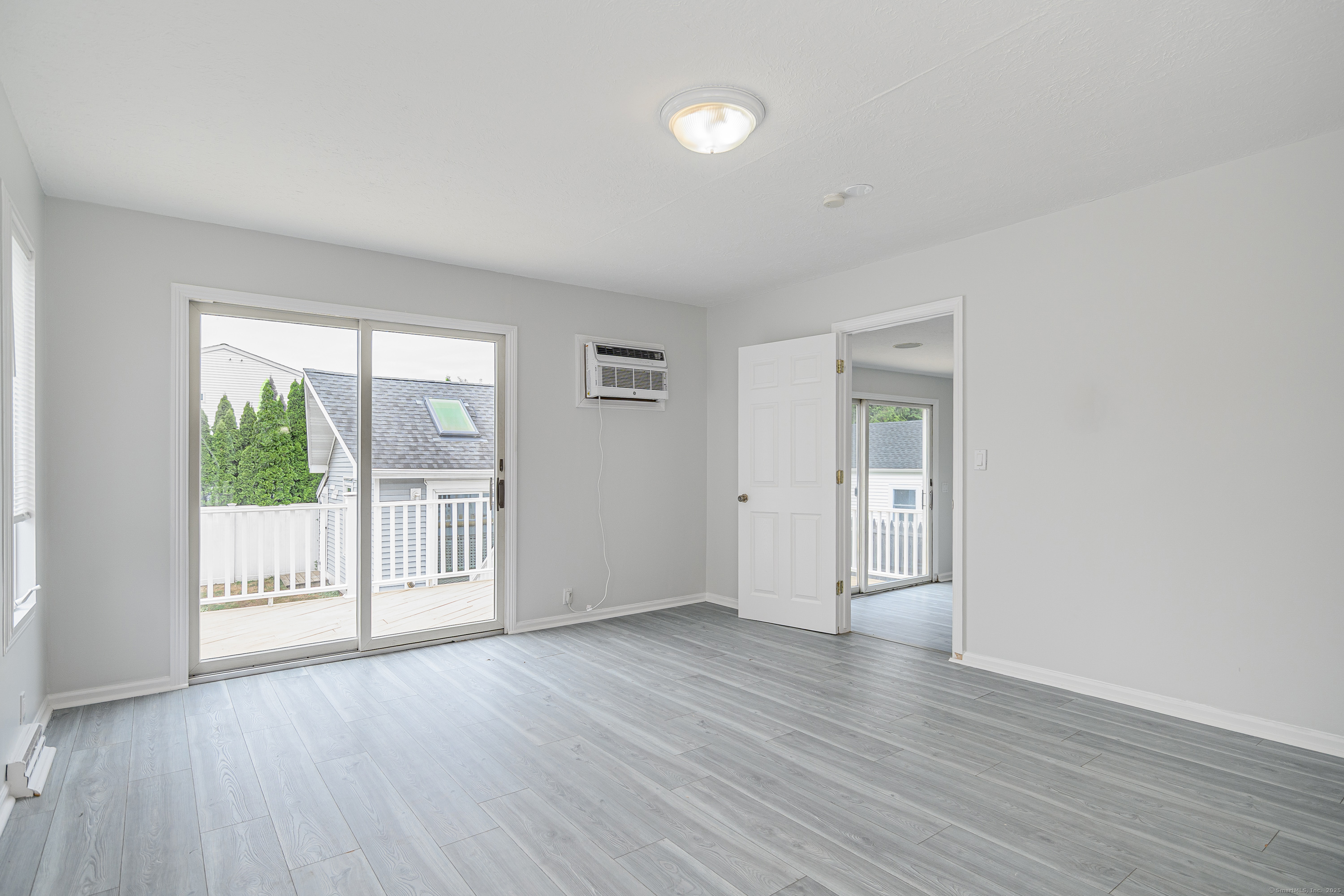 316 Reef Road Fairfield, CT 06824 - Photo 14 of 33 a view of an empty room with wooden floor and a window