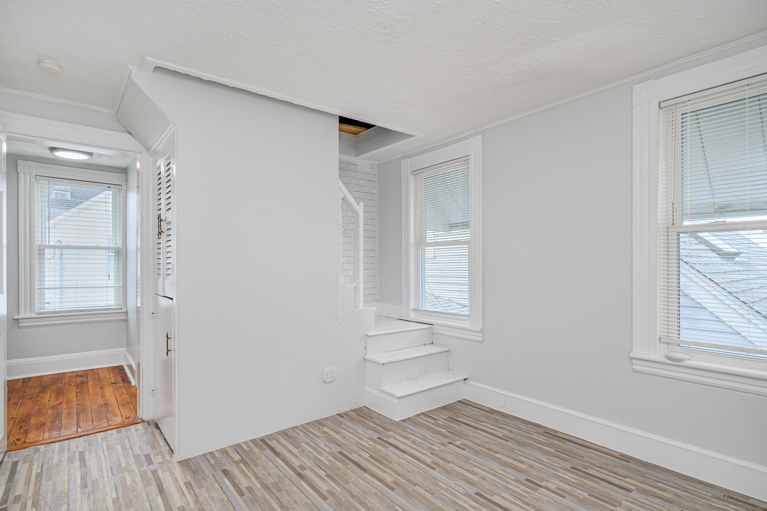 316 Reef Road Fairfield, CT 06824 - Photo 23 of 33 wooden floor in an empty room with a window
