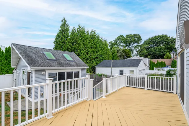 a view of a house with deck and wooden floor