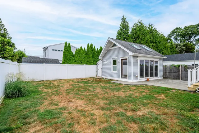 a view of house with backyard and garden