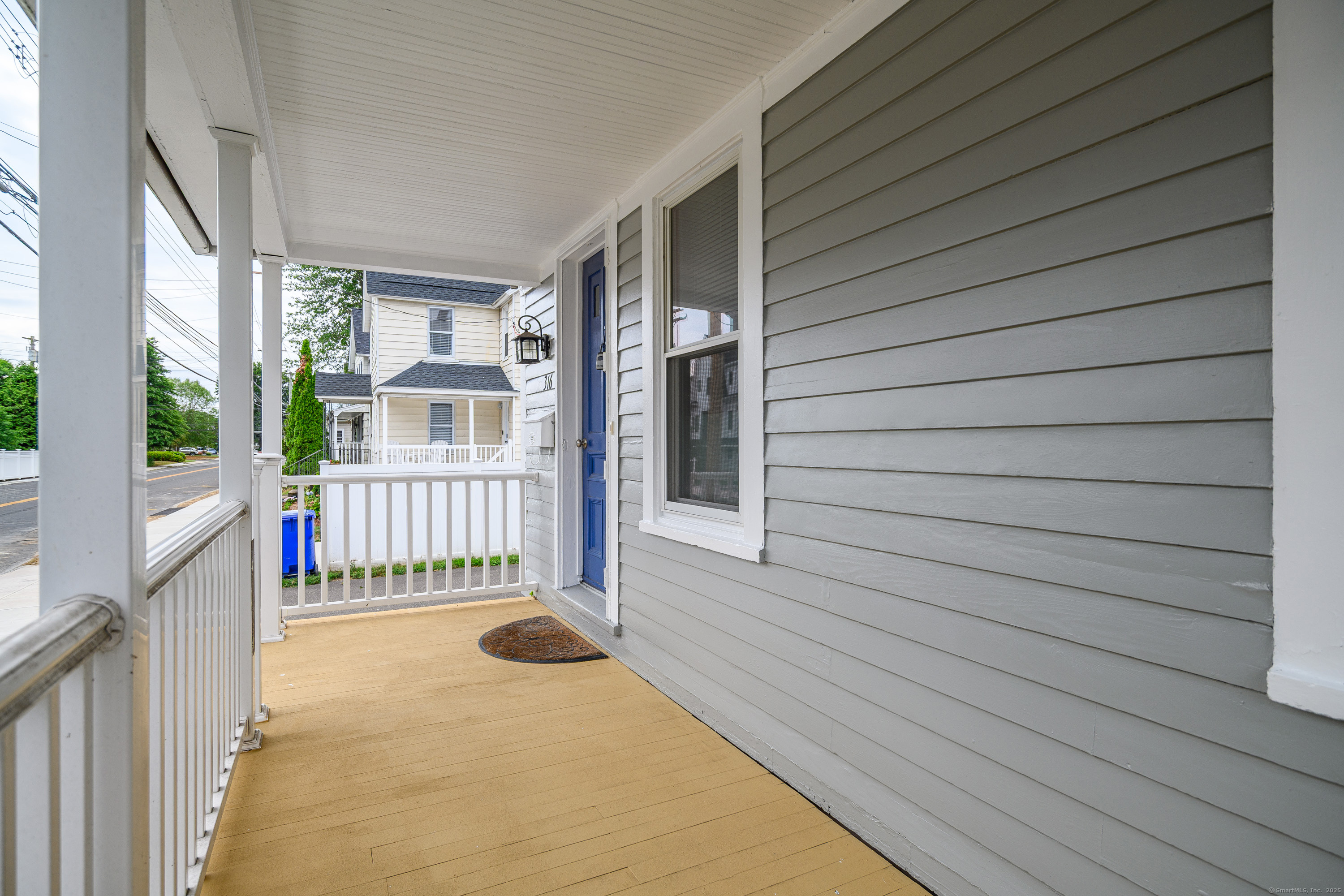 316 Reef Road Fairfield, CT 06824 - Photo 4 of 33 a view of a porch with a table and chair