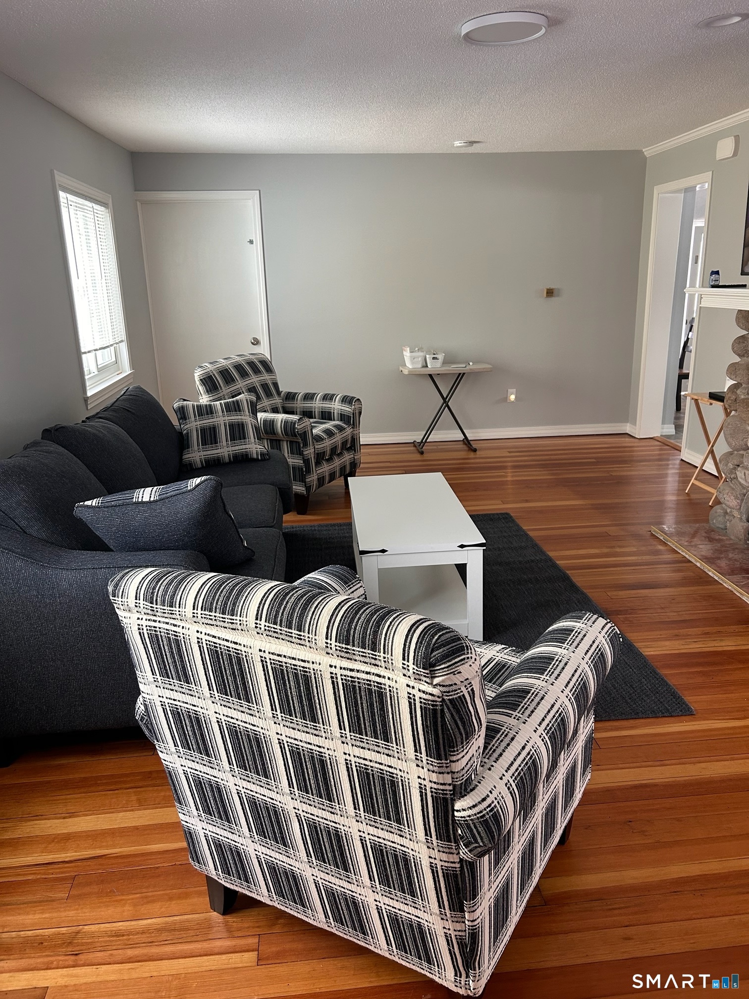 22 Indianola Road East Lyme, CT 06357 - Photo 1 of 18 a living room with a bed and wooden floor