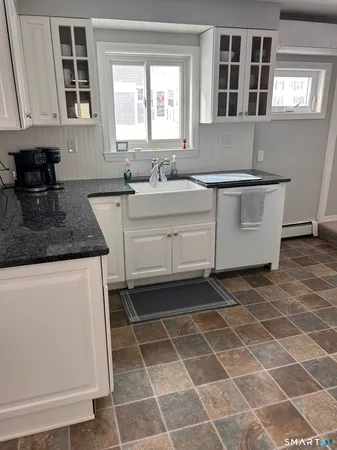 a kitchen with a sink a stove and a microwave