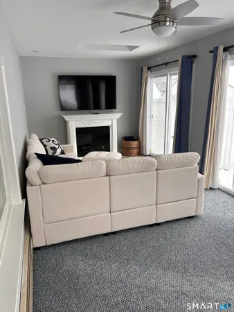 a living room with furniture and a fireplace