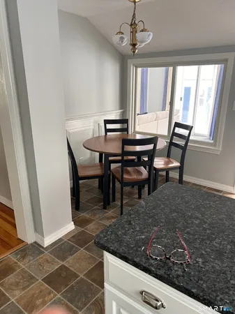 a view of a dining room with furniture and window