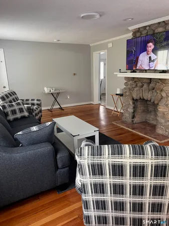 a dinning room with furniture and wooden floor