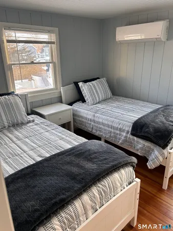 a bedroom with double bed and a window