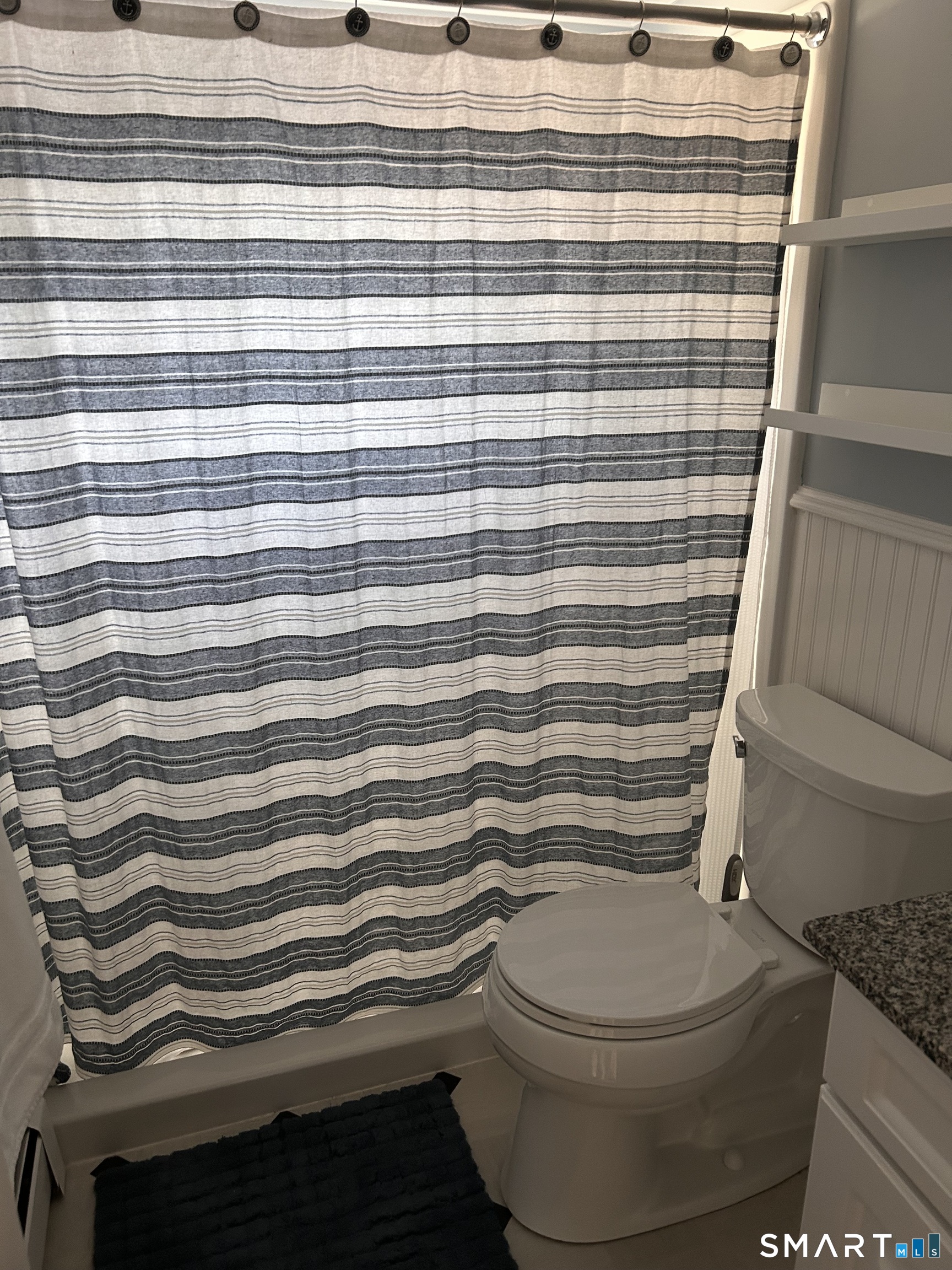 22 Indianola Road East Lyme, CT 06357 - Photo 9 of 18 a bathroom with a toilet and a shower curtain