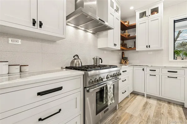 a kitchen with stainless steel appliances white cabinets and a sink