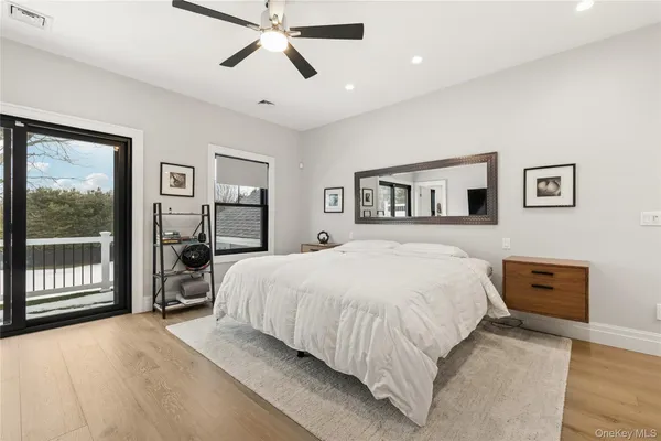 a spacious bedroom with a large bed and a large window
