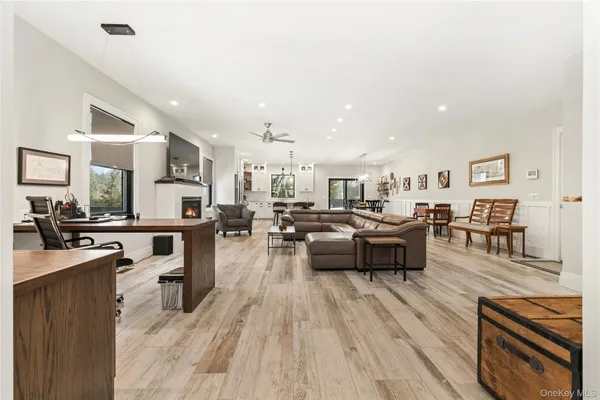 a living room with lots of furniture and kitchen view