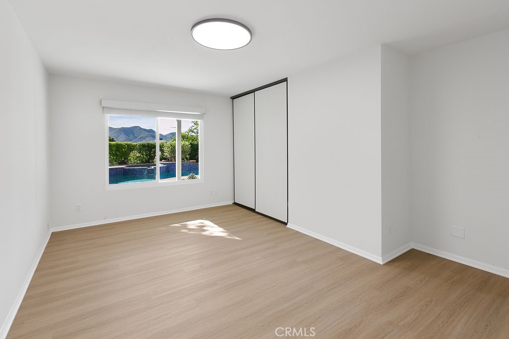 29950 Rolling Ridge Drive Agoura Hills, CA 91301 - Photo 11 of 26 an empty room with wooden floor and windows