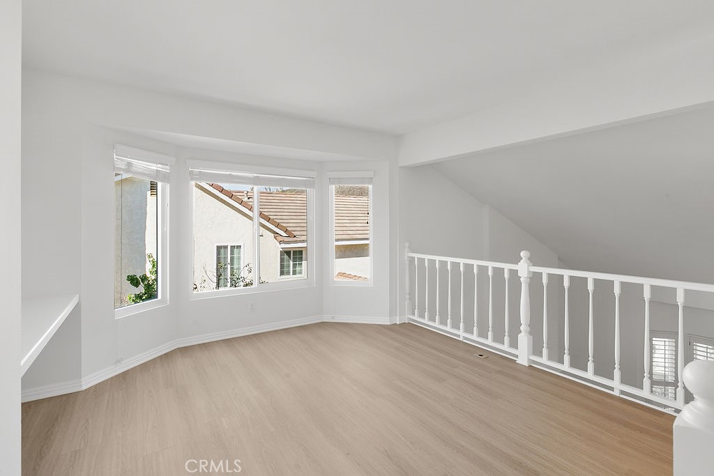 29950 Rolling Ridge Drive Agoura Hills, CA 91301 - Photo 14 of 26 a view of an empty room with wooden floor and a window
