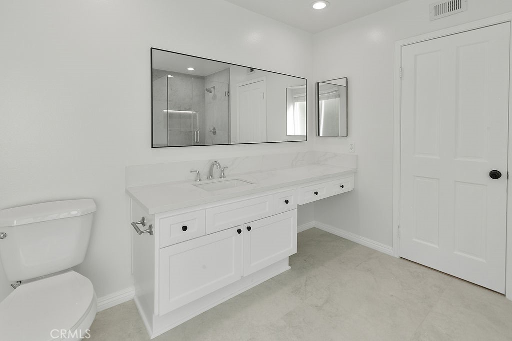 29950 Rolling Ridge Drive Agoura Hills, CA 91301 - Photo 19 of 26 a bathroom with a toilet sink and mirror