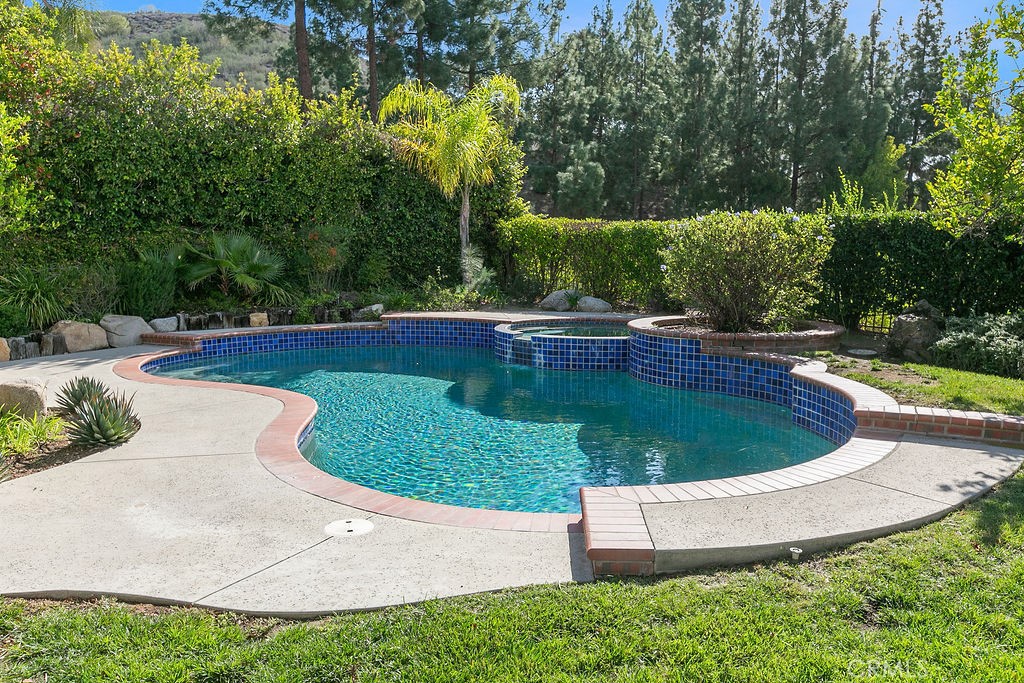 29950 Rolling Ridge Drive Agoura Hills, CA 91301 - Photo 24 of 26 a view of a swimming pool with a yard