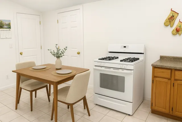 a kitchen with a stove and white cabinets