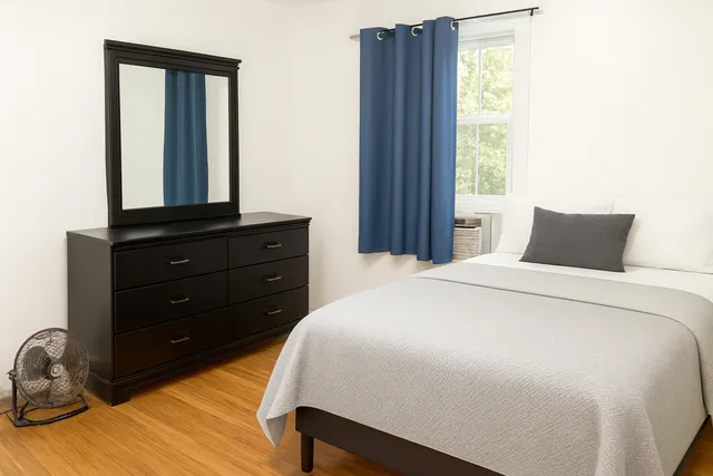 a bedroom with a bed and a window