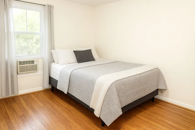 a bedroom with a bed and a window