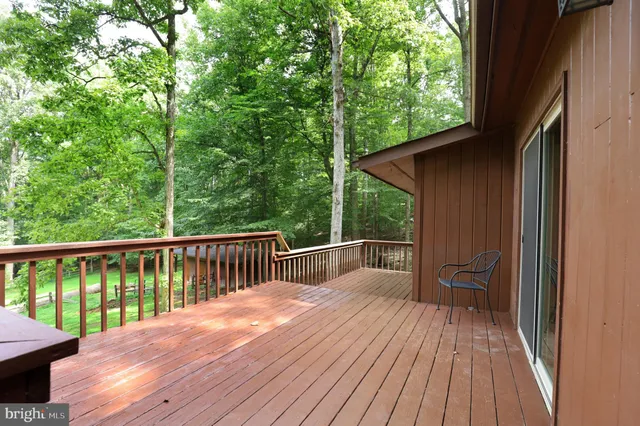 a view of outdoor space with deck and yard