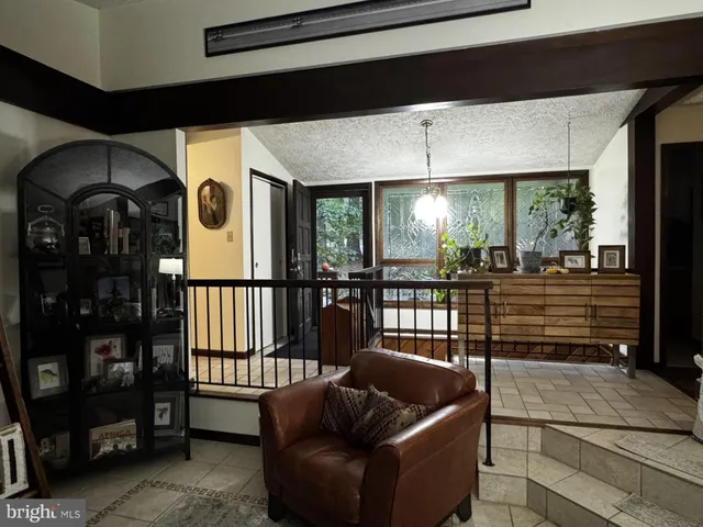 a view of an empty room with a fireplace and wooden floor