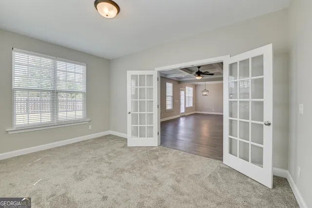 an empty room with entrance and windows