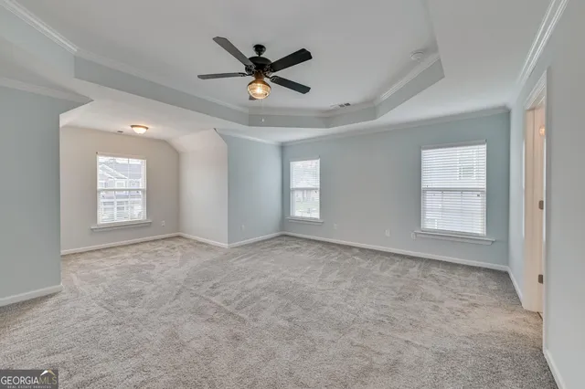 a view of a livingroom with a ceiling fan and window