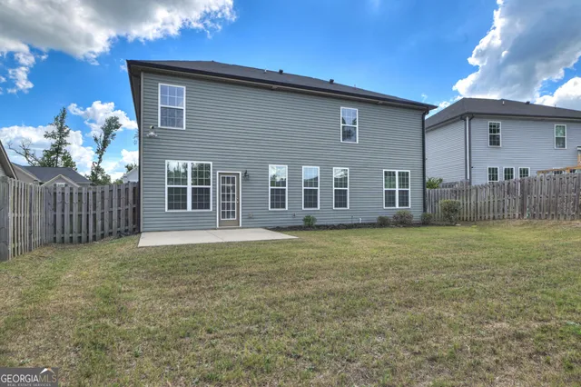 a view of a house with a backyard