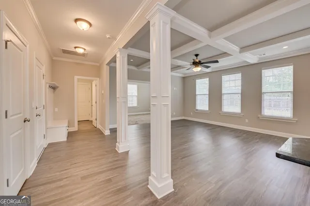 wooden floor in an empty room with a window