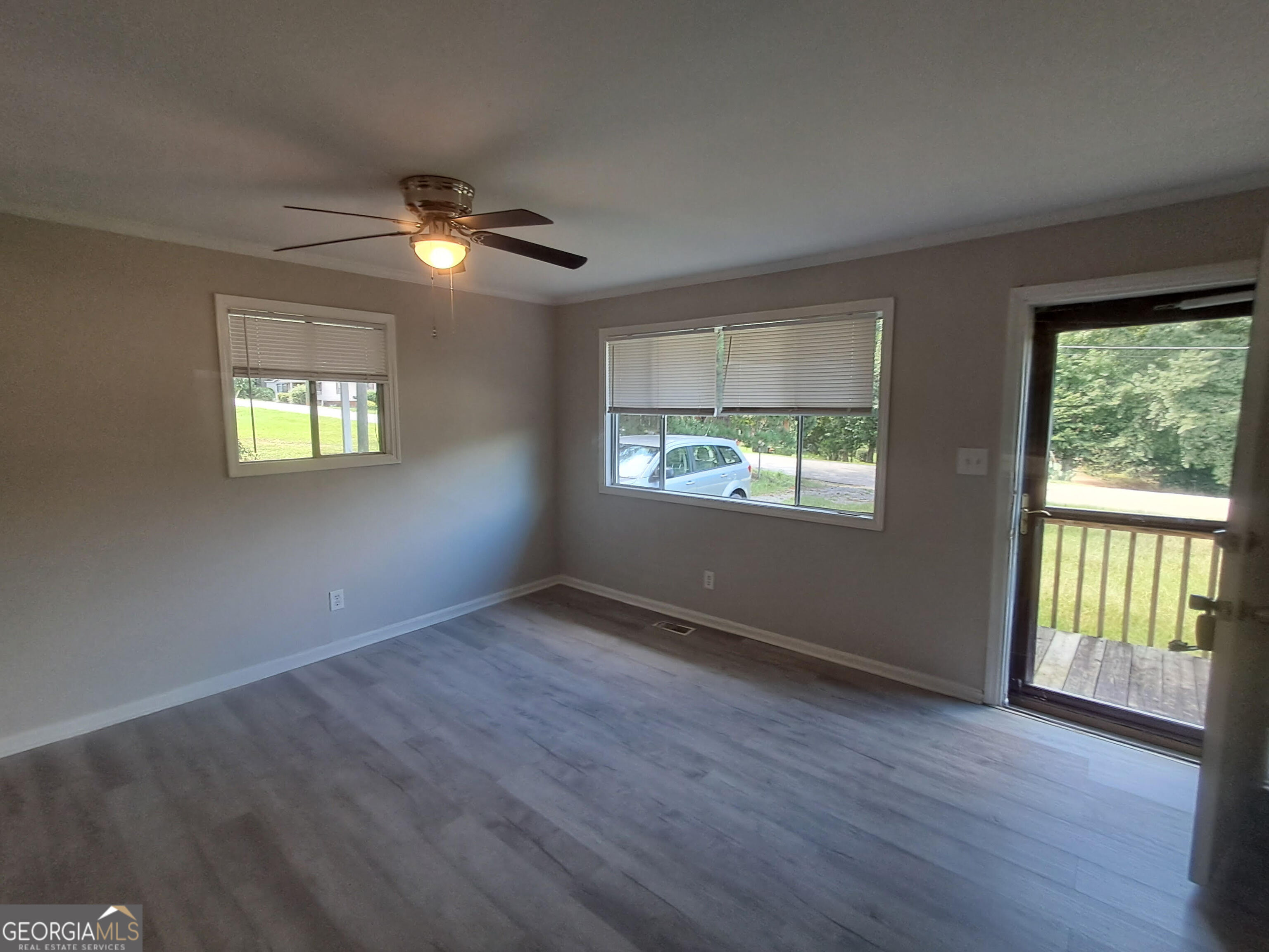 193 Frazier Drive Southeast Milledgeville, GA 31061 - Photo 11 of 38 a view of an empty room with wooden floor and a window